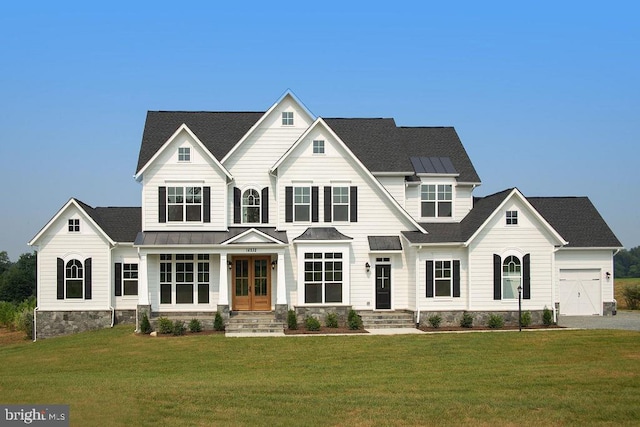 craftsman-style house featuring a front yard, french doors, metal roof, and a standing seam roof