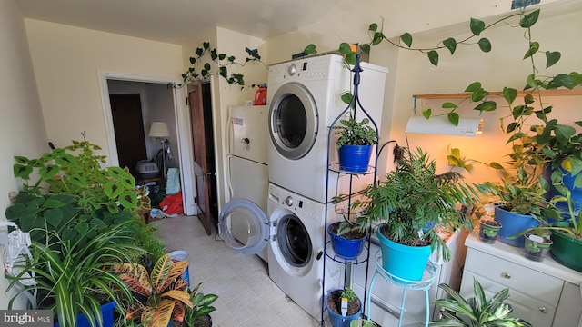 clothes washing area with laundry area and stacked washer / drying machine