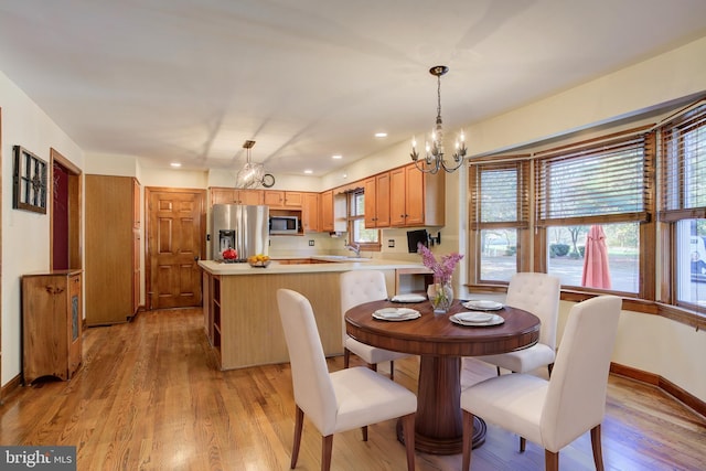 dining area featuring a notable chandelier, light wood finished floors, recessed lighting, and baseboards