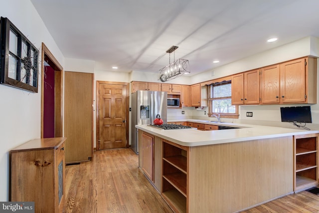 kitchen featuring open shelves, stainless steel appliances, light countertops, light wood-style flooring, and a peninsula