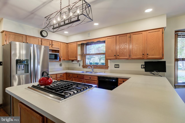 kitchen featuring stainless steel appliances, recessed lighting, light countertops, and a sink