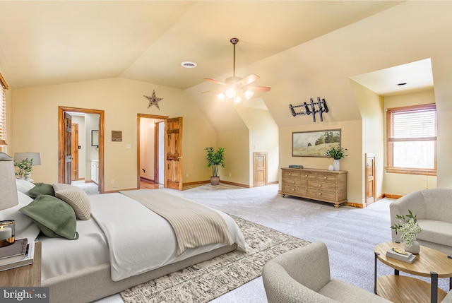 bedroom with carpet, vaulted ceiling, baseboards, and ensuite bathroom