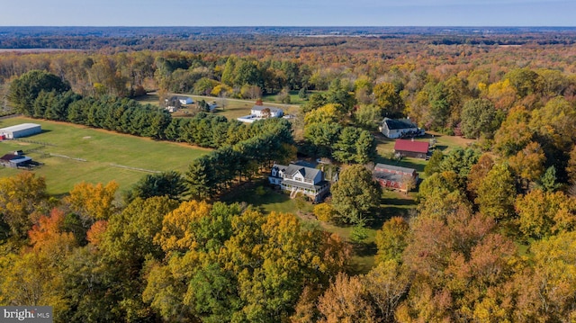 birds eye view of property with a view of trees