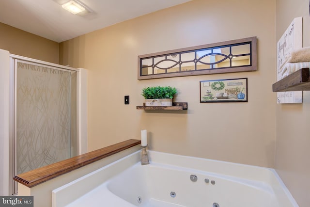 bathroom featuring a whirlpool tub and a shower stall