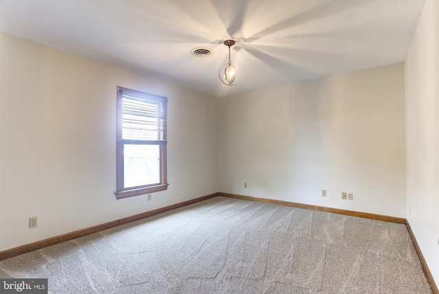 carpeted empty room with baseboards and visible vents