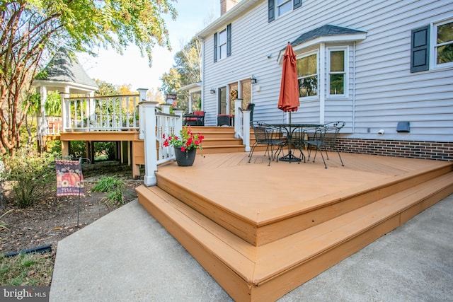 wooden deck featuring outdoor dining area