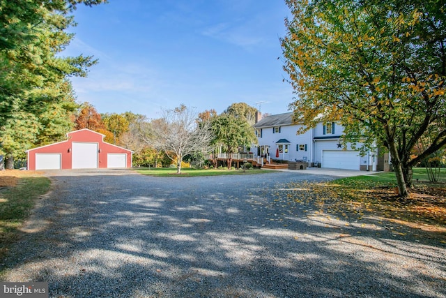 view of front of property with gravel driveway and an outdoor structure