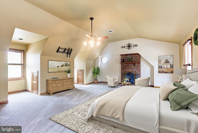 carpeted bedroom featuring lofted ceiling, a fireplace, and baseboards