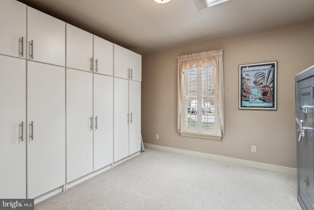 unfurnished bedroom featuring carpet flooring and baseboards