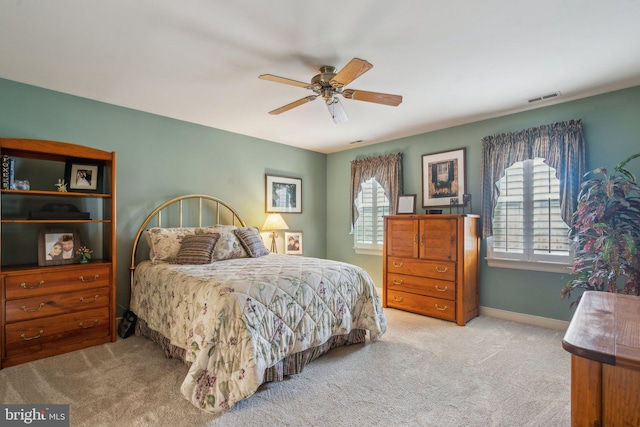 bedroom featuring baseboards, visible vents, ceiling fan, and carpet flooring