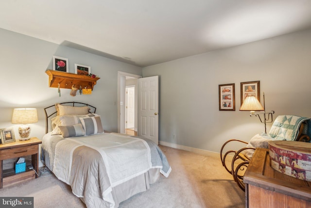 bedroom featuring carpet and baseboards