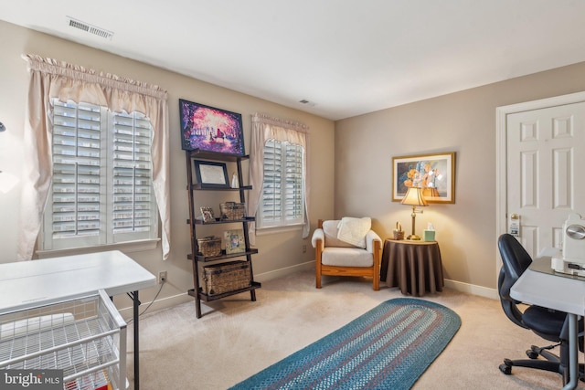 carpeted office space with a healthy amount of sunlight, baseboards, and visible vents