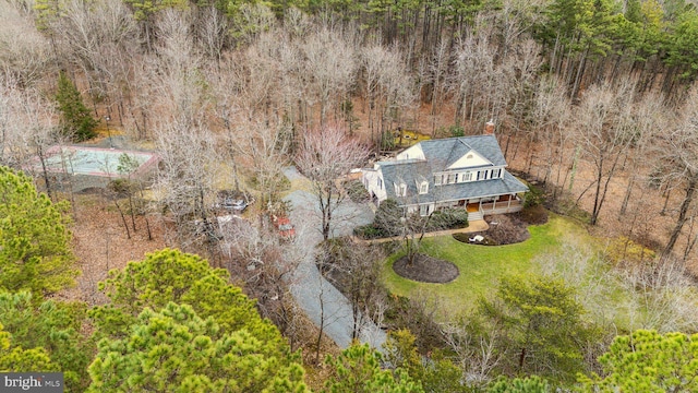 birds eye view of property with a view of trees