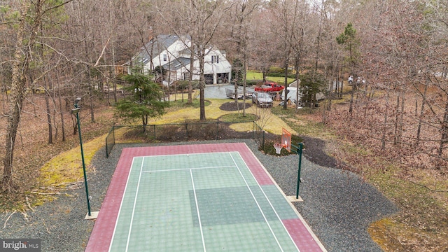 view of sport court featuring basketball court and fence