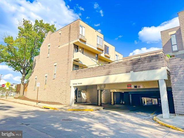 view of building exterior with parking