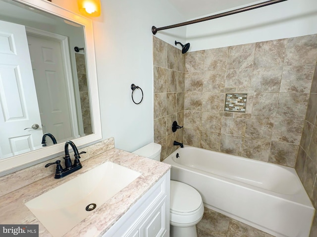 bathroom featuring washtub / shower combination, vanity, and toilet