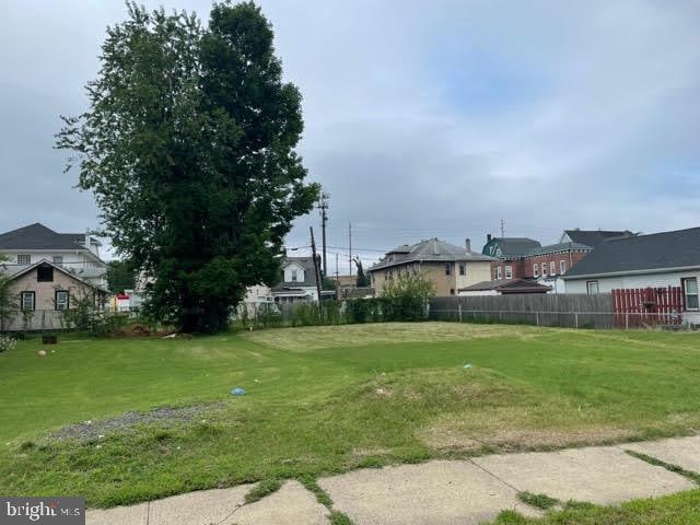 view of yard featuring a residential view and fence