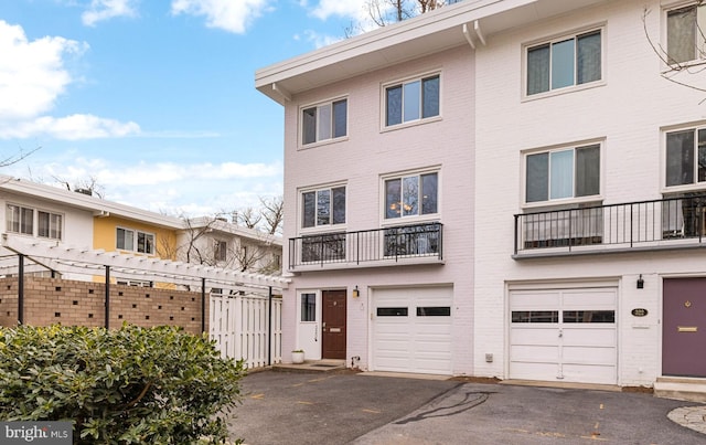 view of property with driveway and an attached garage