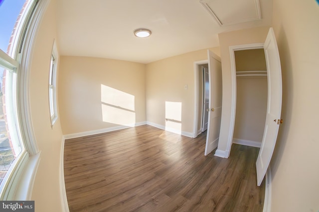 unfurnished bedroom featuring a closet, baseboards, and wood finished floors