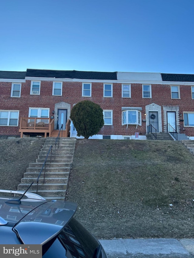 townhome / multi-family property featuring brick siding