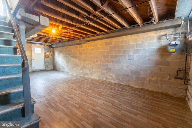 below grade area with stairway and wood finished floors