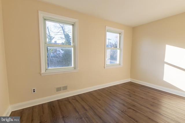 spare room with baseboards, visible vents, and a healthy amount of sunlight