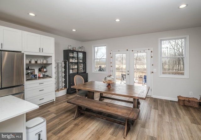 dining space featuring recessed lighting, french doors, dark wood finished floors, and baseboards