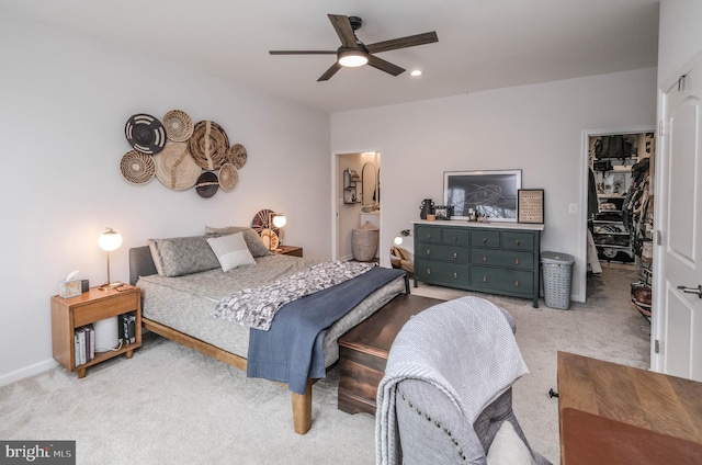 bedroom with a ceiling fan, a walk in closet, carpet floors, a closet, and recessed lighting