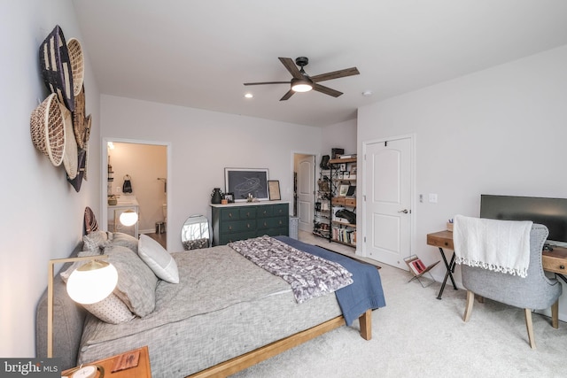 bedroom with ensuite bathroom, carpet floors, and a ceiling fan