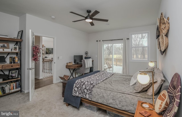 bedroom featuring access to exterior, a ceiling fan, baseboards, and carpet flooring