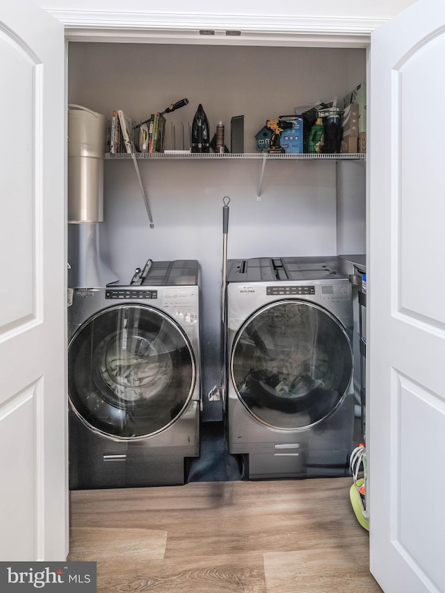 laundry room featuring independent washer and dryer and wood finished floors