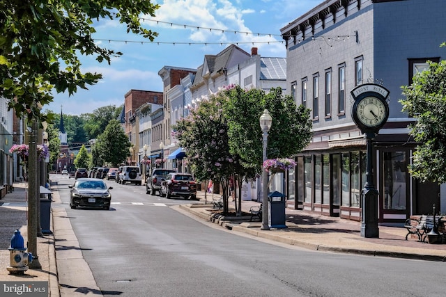 view of road with curbs, street lighting, and sidewalks