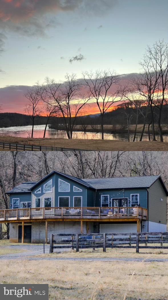 view of front of property with fence and a wooden deck