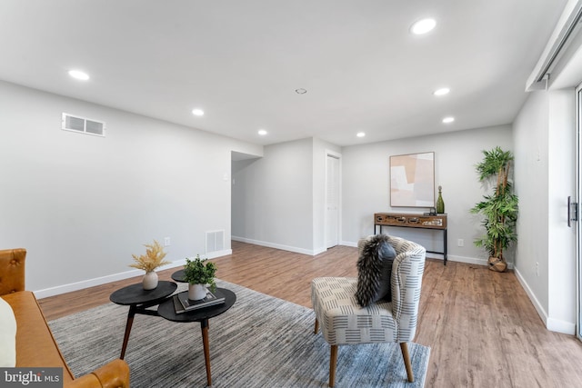 living room featuring recessed lighting, visible vents, and light wood-style floors