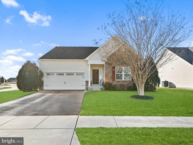 view of front of property featuring concrete driveway, stone siding, an attached garage, central AC, and a front yard