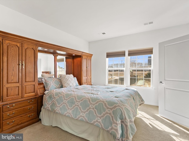 bedroom with light colored carpet and visible vents