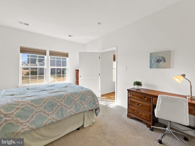 bedroom featuring carpet floors, visible vents, and baseboards