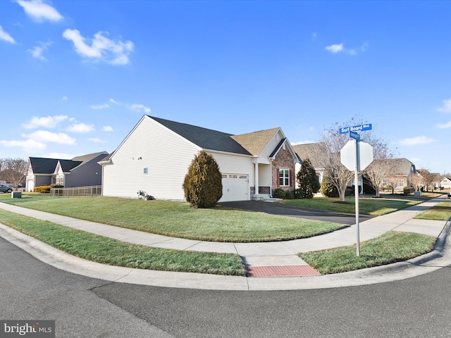 single story home featuring aphalt driveway, a front yard, a residential view, and an attached garage