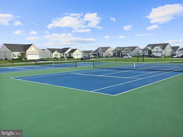 view of sport court with a residential view and fence