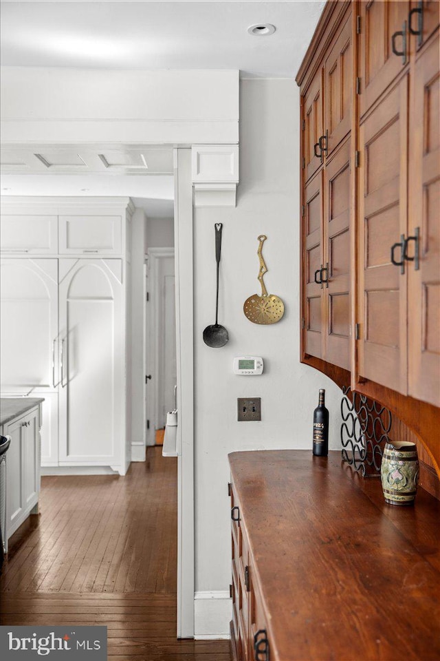 corridor featuring dark wood finished floors