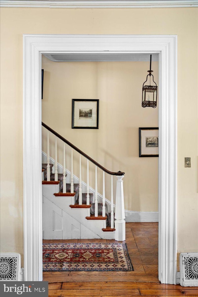 stairway with baseboards and wood-type flooring