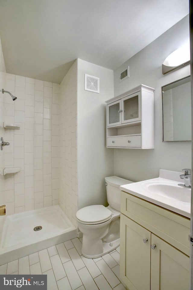 bathroom featuring a stall shower, visible vents, vanity, and toilet