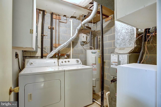 washroom featuring water heater, laundry area, and independent washer and dryer