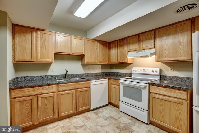 kitchen with under cabinet range hood, white appliances, a sink, visible vents, and dark stone counters