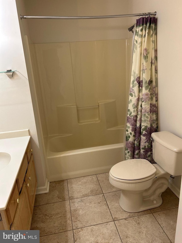 bathroom featuring tile patterned flooring, shower / tub combo, toilet, and vanity