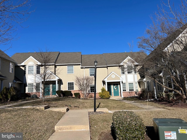 townhome / multi-family property featuring brick siding