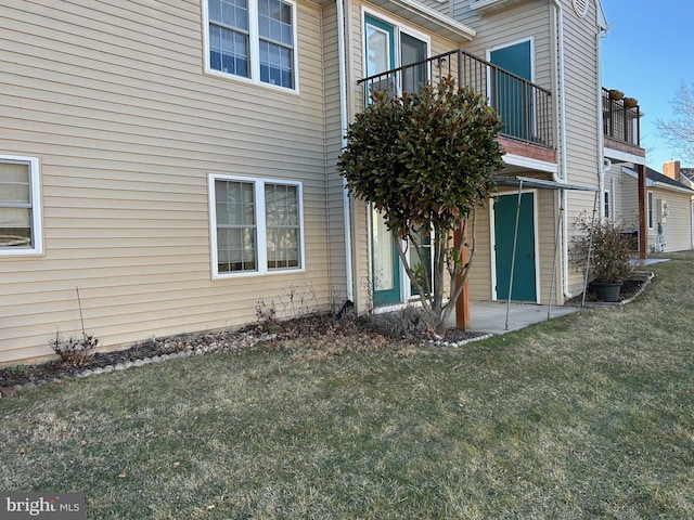 view of property exterior with a lawn