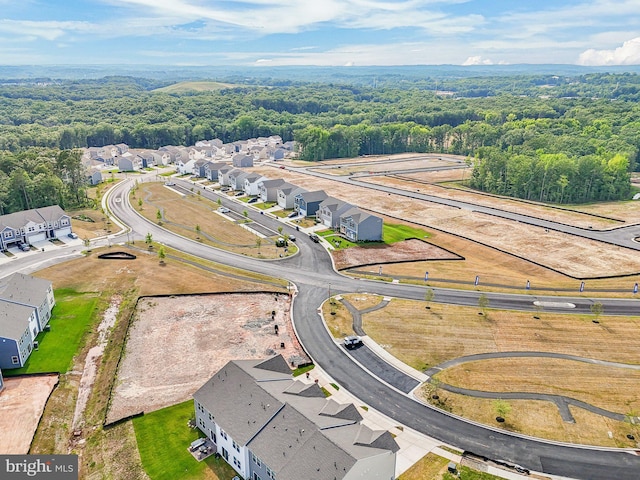 birds eye view of property featuring a residential view and a forest view