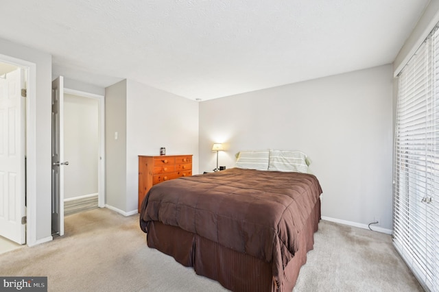 carpeted bedroom featuring baseboards