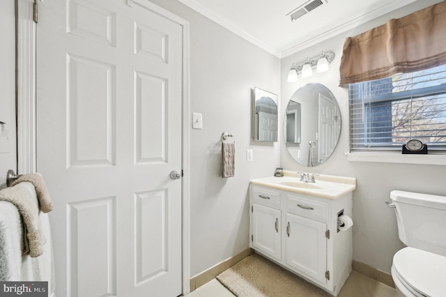 bathroom with visible vents, toilet, ornamental molding, baseboards, and vanity